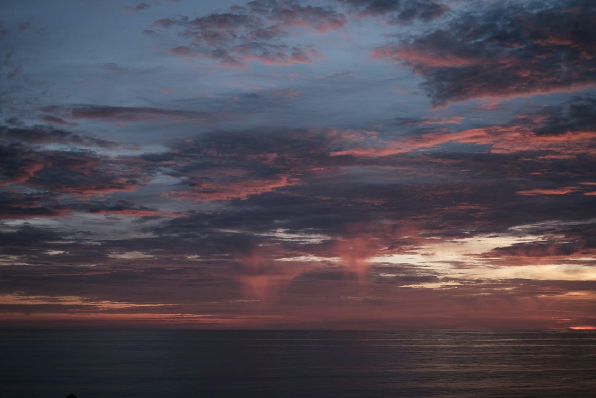 a sunset over a large body of water